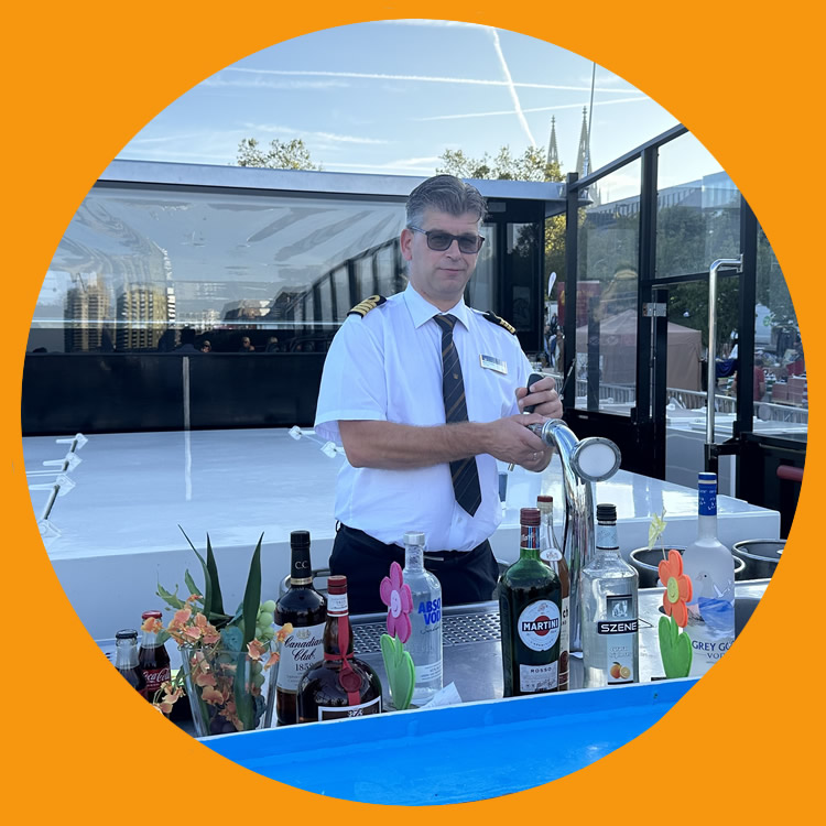 River cruise captain pulling double duty - serving drinks at the outside bar
