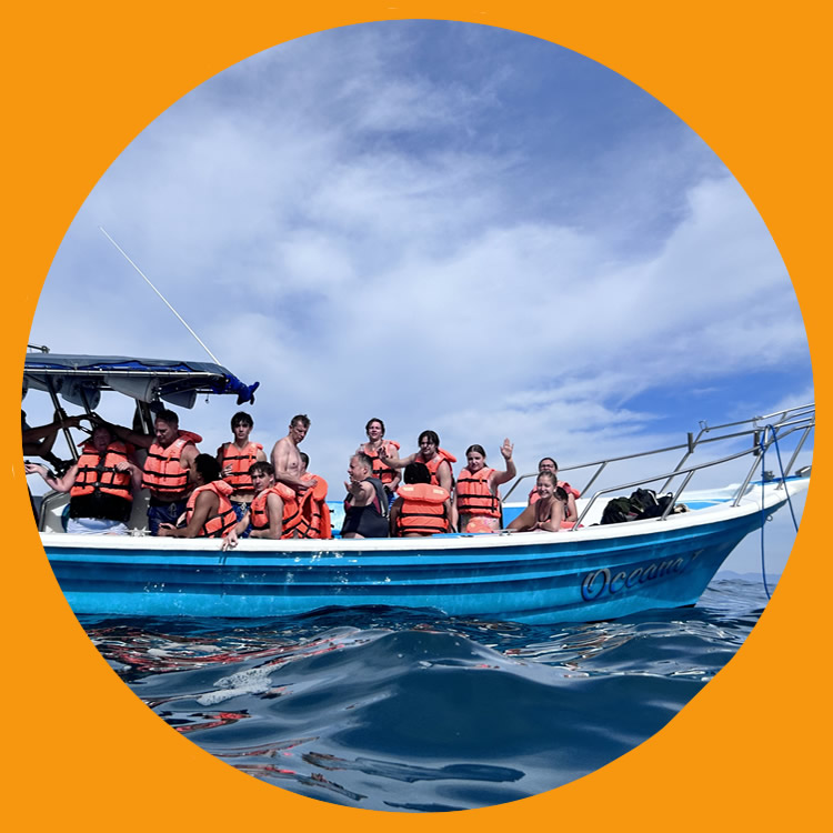 day trip on the ocean, people in lifejackets enjoying the sights