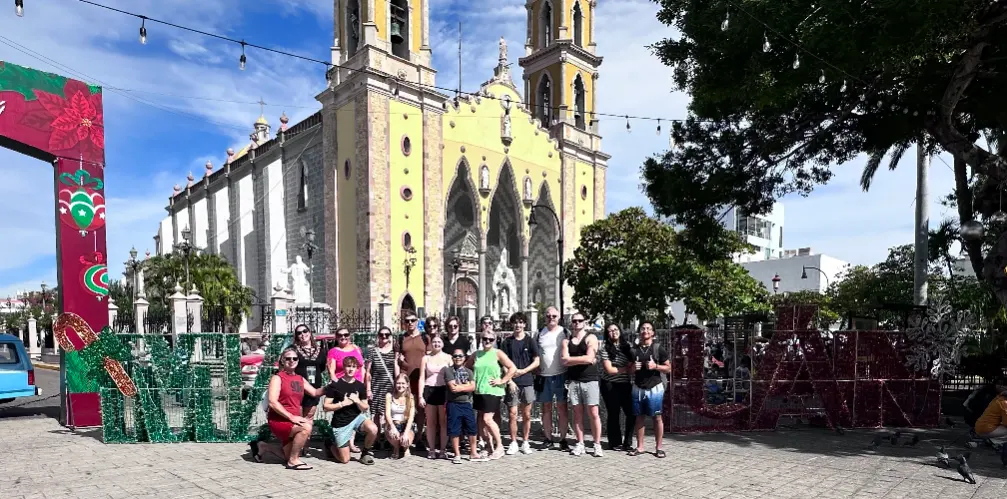 Group of friends on vacation together posing at church