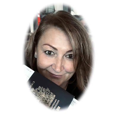 Irena Struk, founder of Struck by Travel, in her office holding a passport and airline tickets